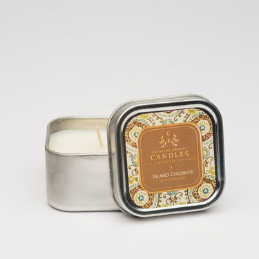 Island Coconut Soy Lotion Candle in a decorative tin with 'Island Coconut' label on a light gray background