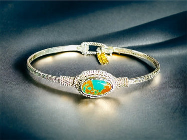 Silver bracelet with a turquoise stone on a dark background