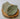 Two ceramic leaves on a wooden stump against a white background