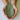 Person holding a leaf-shaped ceramic pot with a greenish-brown color.