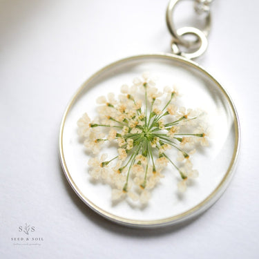 Keychain with pressed flowers Pressed Botanical Pendants on a white background