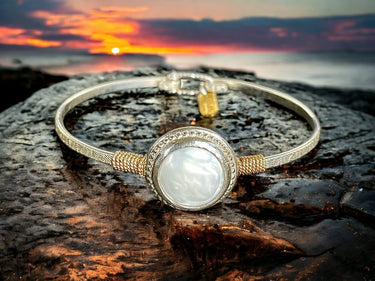 Bracelet with a circular design on a rock during sunset