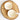Two round soap bars with monogram designs on a wooden surface