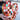Heart-shaped object made of interlocking wooden pieces held by a person.