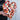 Heart-shaped object made of interlocking wooden pieces held by a person.