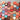 Collection of colorful heart-shaped wooden decorations with various designs and text.