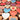 Colorful heart-shaped wooden tokens with 'LOVE', 'XOXO', and hand gesture symbols.