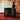 Black labeled Omega organic products on a wooden surface with a blurred background