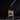 Bottle of Johnny Slicks organic beard oil with a dropper on a dark background
