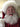 Person dressed as Santa Claus with a white beard and red suit.