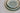 Stack of ceramic bowls with a gradient blue and white finish on a light gray background