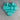 Turquoise heart-shaped silicone mold on a beige surface
