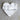 White marble heart-shaped object on a light brown surface