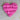 Pink heart-shaped object on a beige surface