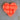 Orange heart-shaped object on a textured surface