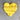 Yellow heart-shaped object on a textured surface