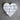 White heart-shaped cookie cutter on a textured surface