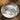 Silver coin with a pig design on a textured fabric background