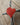 Red heart-shaped object on a wooden surface