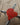 Red heart-shaped object on a wooden surface
