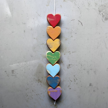 Colorful heart-shaped wooden ornament on a gray background