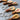 Wooden guitar-shaped keychains on a metal surface