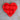 Red heart-shaped object on a beige surface