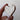 Heart-shaped object with marble pattern held by a hand against a plain background