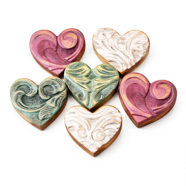 Heart-shaped cookies with colorful swirled icing on a white background