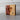 Wooden block with a heart cutout on a light wooden background