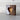 Wooden block with a heart-shaped cutout on a marble surface