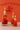 Three lit candles in bottles with red liquid and flowers against an orange background with a Sagittarius symbol.