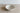 White ceramic bowl with brown rim on a wooden surface