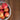 White bowl filled with red apples on a wooden surface
