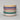 Stack of colorful ceramic bowls on a light gray background