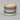 Stack of colorful ceramic bowls on a gray background