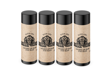 Four lip balm containers with black lids on a white background