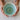 Person holding a ceramic bowl with a blue interior on a white background