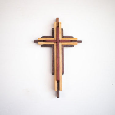 Wooden cross wall art on a white background
