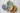 Four ceramic leaf-shaped plates in different colors on a light background
