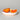 Sliced orange on a white plate with a gray background