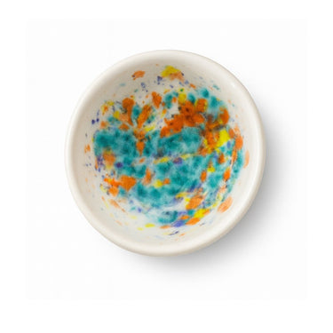 Small ceramic bowl with colorful abstract pattern on a white background