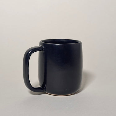 Black mug on a light gray background