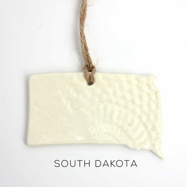 Rectangular ceramic sign with 'South Dakota' text on a white background