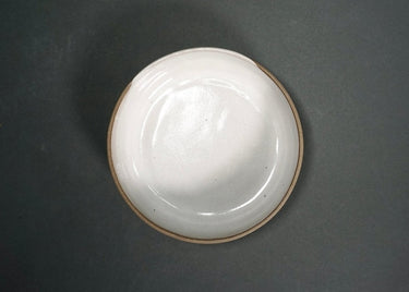 White ceramic plate on a dark gray background