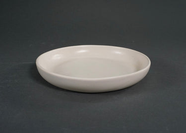 White ceramic plate on a dark gray background