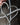 Metal heart-Promise Cross held by a hand against a blurred background