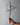 Hand holding a metal Promise Cross with an interlocking heart against a steel gray background
