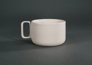 White ceramic mug on a dark gray background
