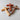 Three wooden cross-shaped objects on a light gray surface